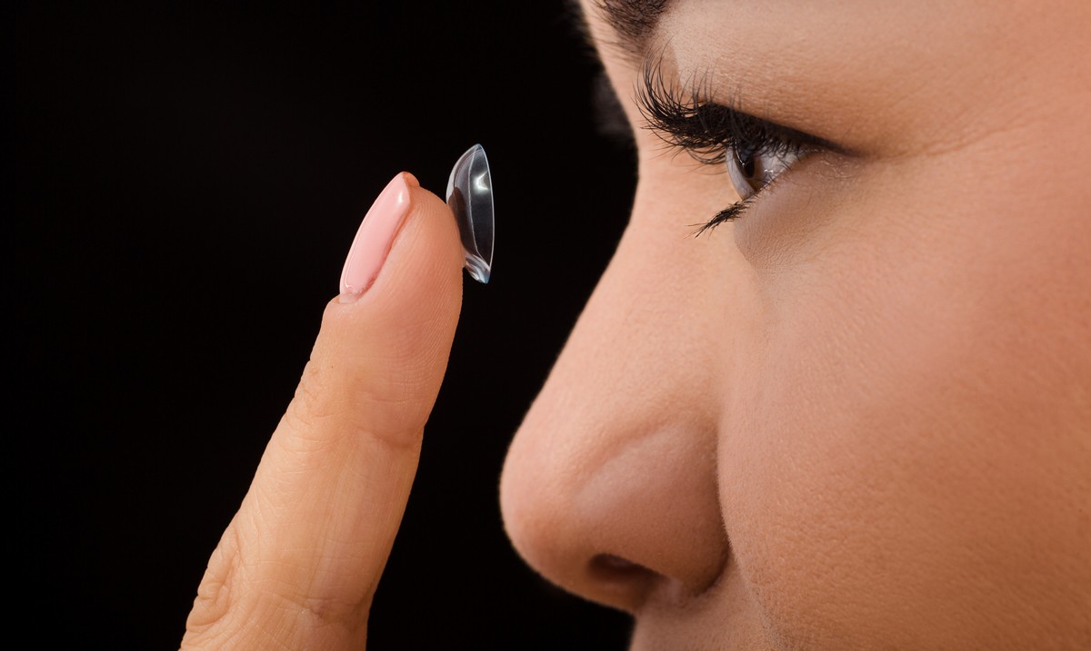 Close-up of woman inserting contact lens