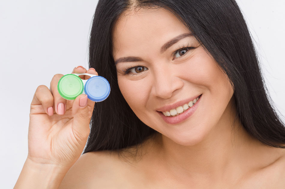 Happy woman holding contacts case