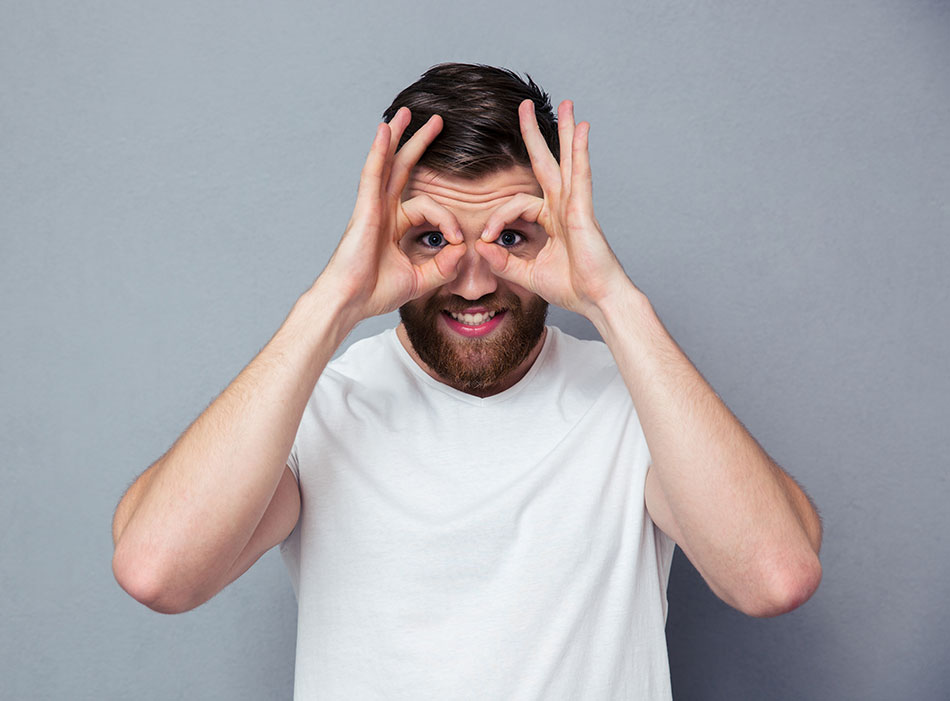 Man with hands as binoculars over eyes