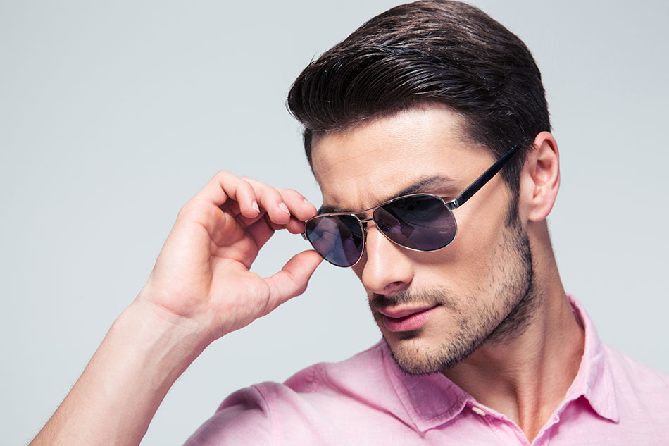 man in pink shirt wearing dark sunglasses