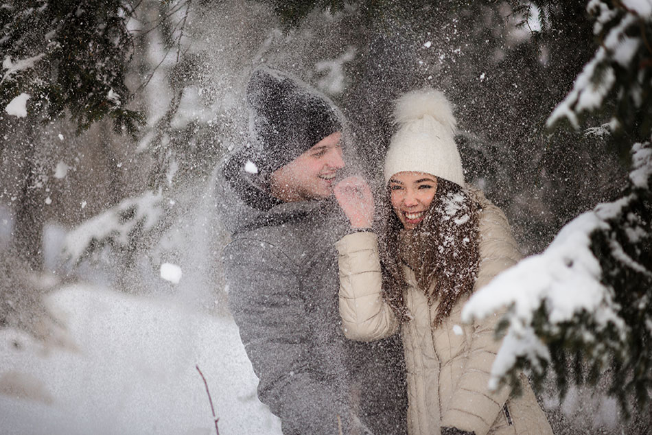 man and woman playing in snow