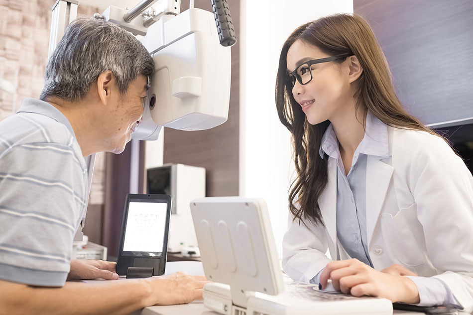 Middle-aged man getting eye test at optometrist’s office